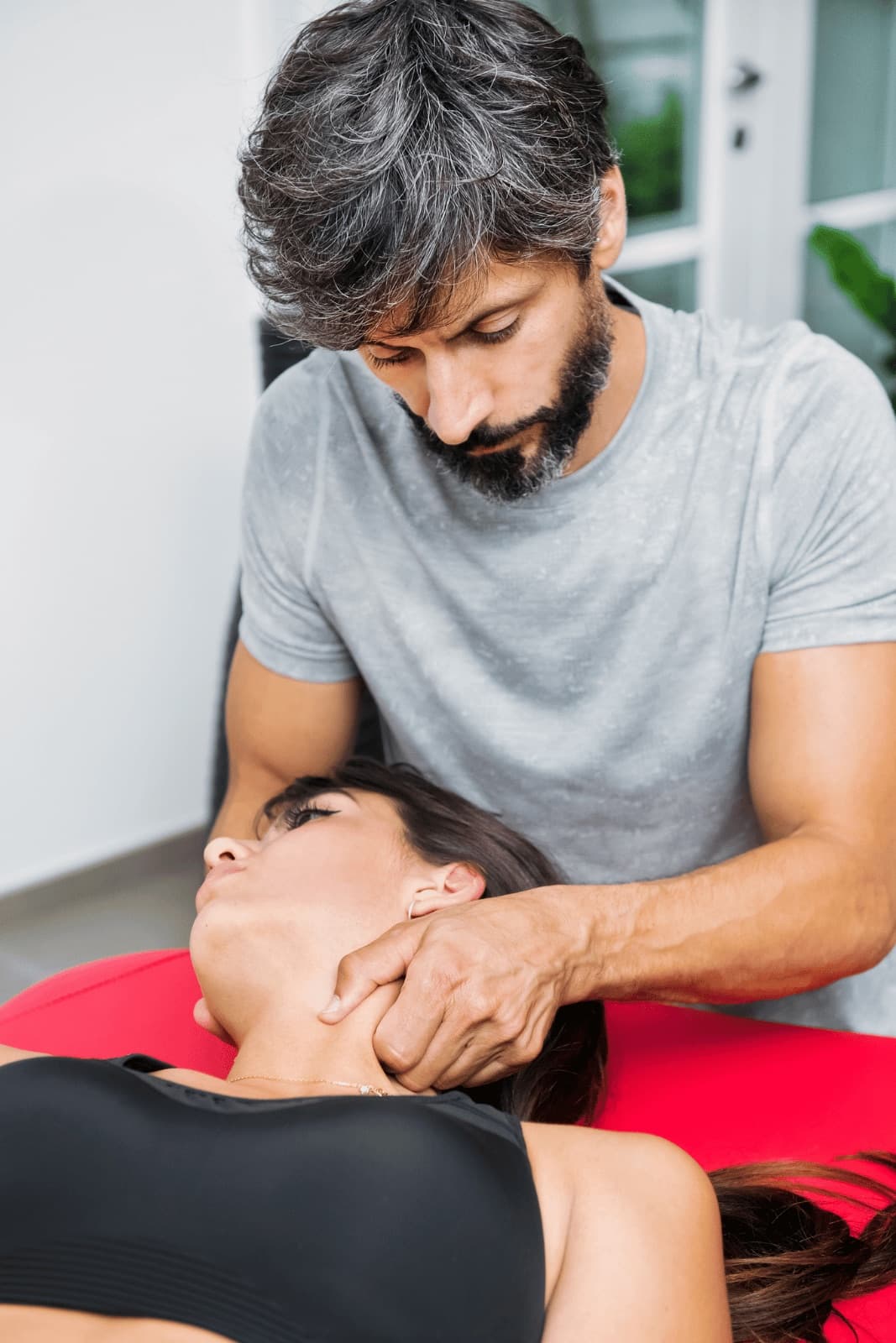 An osteopath treating a patient on a clinic couch